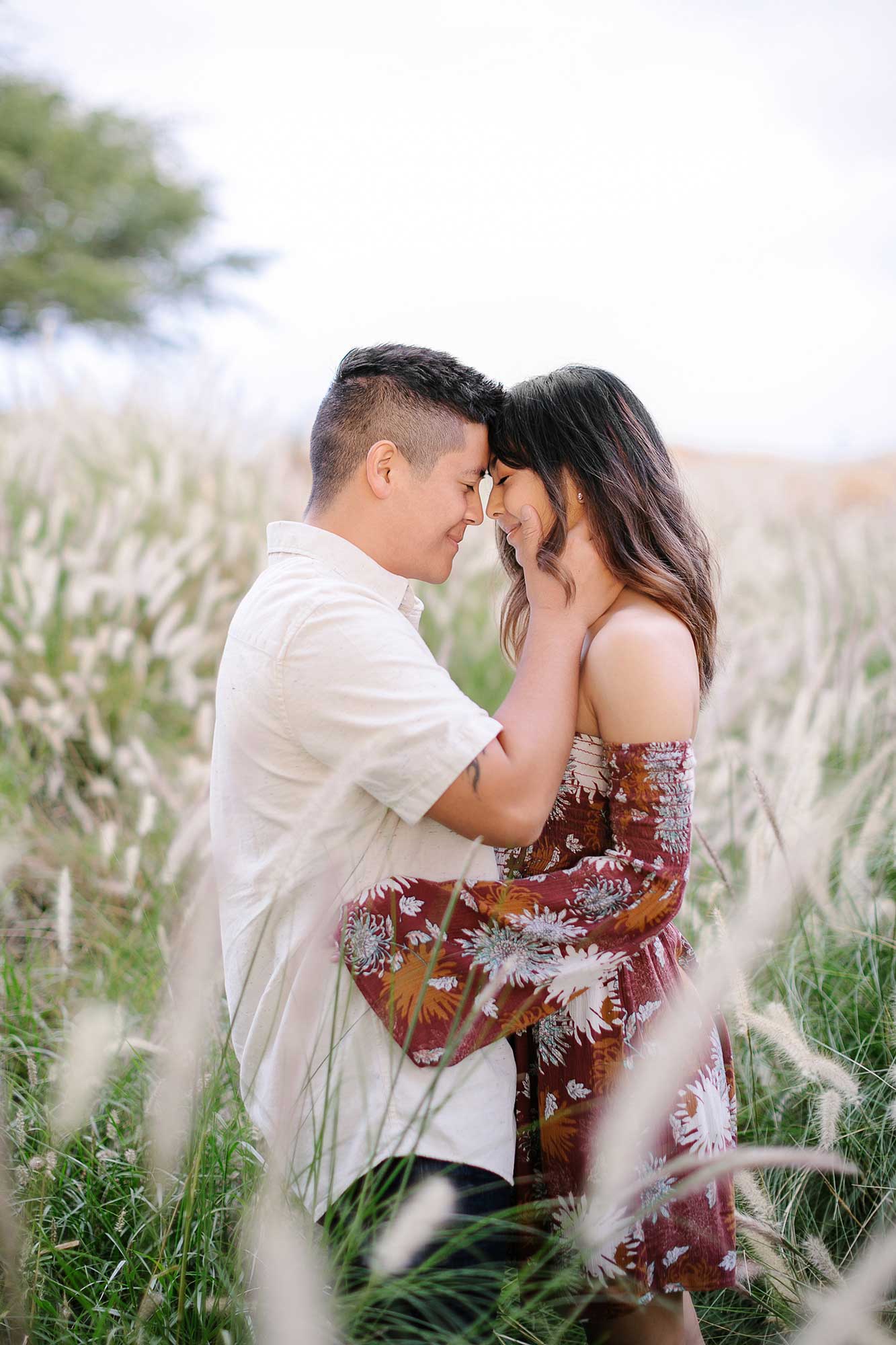 image of couple cuddling in the grass