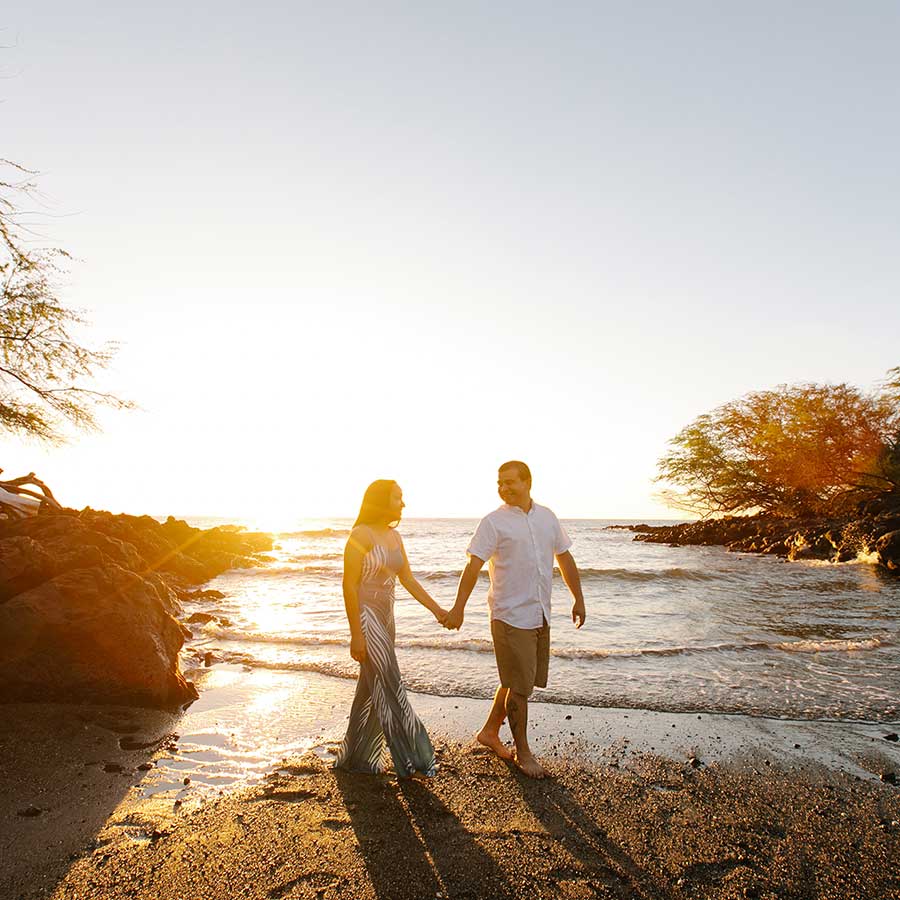 image of couple holding hands next to the beach