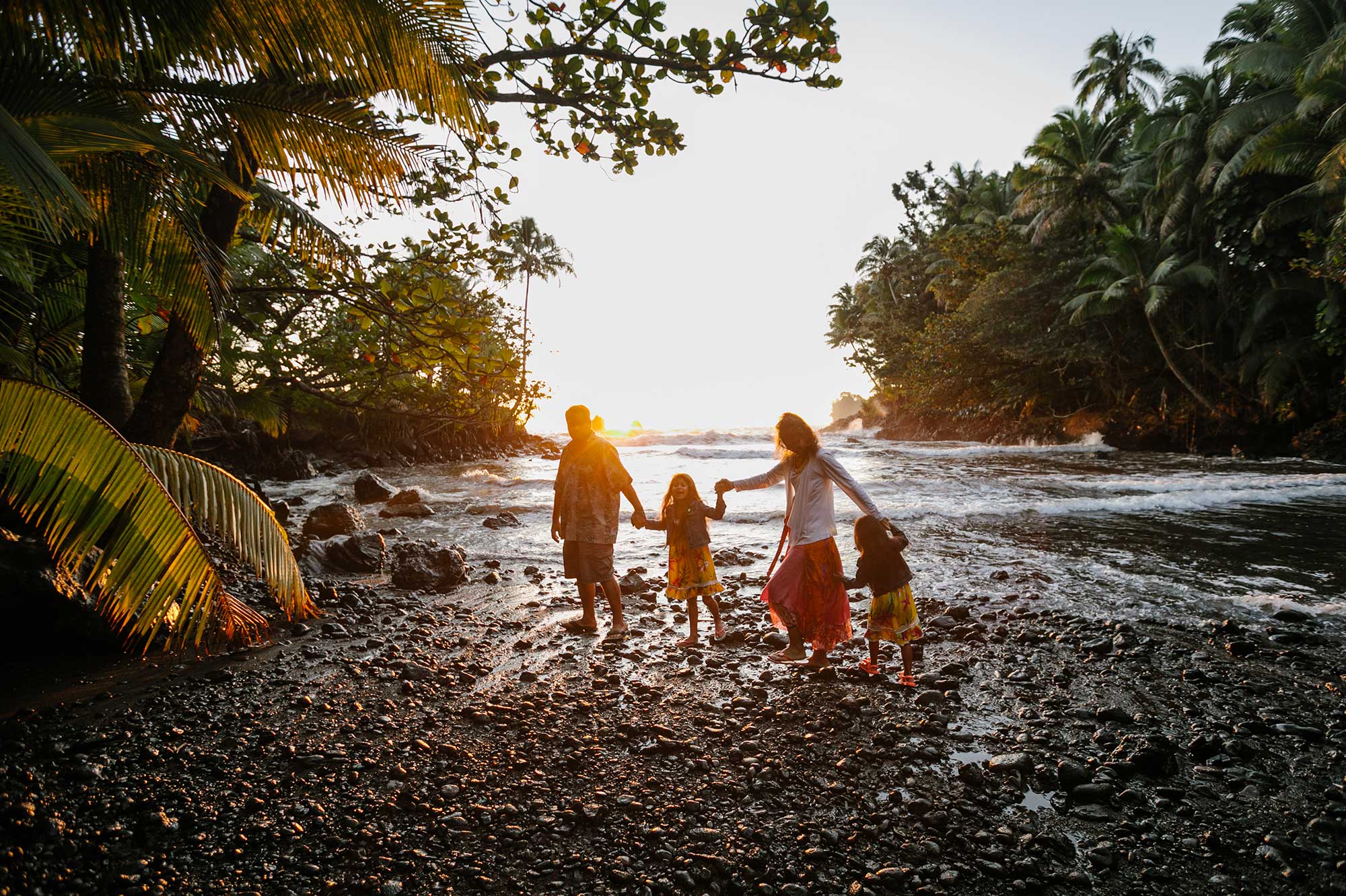 image of family of 4 walking together near the water
