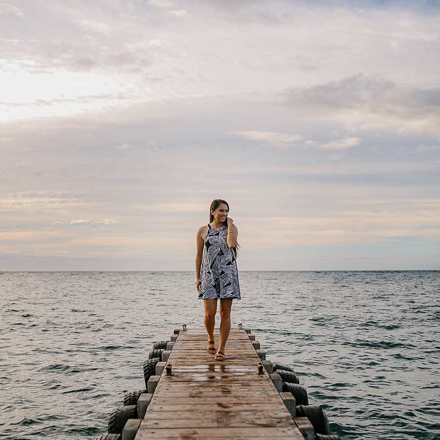 image of a senior portrait of a girl walking on a pier